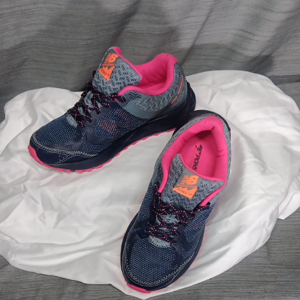 Sold.   New Balance Women's Navy and Pink Sneakers